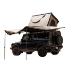 A black off-road SUV is outfitted for camping with a rooftop tent and the CVT 180 Degree Awning, both fully extended. The tent is open and the spacious CVT awning instantly provides shade along one side of the vehicle, creating a comfortable outdoor shelter for any adventure.