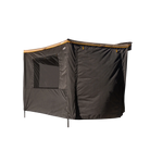 The CVT 270 Degree Awning Wall is a rectangular black canopy with a brown trim, featuring one large window and extended side panels for enhanced weather protection and versatility—ideal for use as a camping awning wall. Shown against a plain white background.