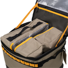 Introducing the CVT Soft Side Storage™: an open tan and black duffel bag with yellow zipper trim, featuring a water-resistant organizer interior, two included packing cubes, an insulated lid lining, and collapsible storage for convenient travel and everyday organization.