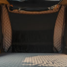 The image shows the interior of a CVT Wasatch Hardshell Tent, featuring quilted fabric walls, a mesh window or partition, and a padded, textured sleeping surface in the foreground—perfect for your next overland adventure.