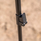 A close-up of a black adjustable pole with a locking lever mechanism—an essential support for the CVT 270 Degree Awning—set against a blurry outdoor background.
