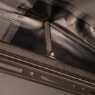 Close-up of a metal support rod attached to a black frame, holding up a section of gray and clear fabric from the CVT 270 Degree Awning.