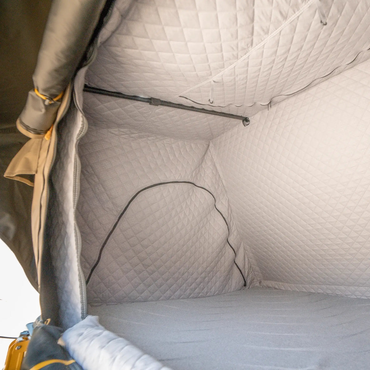 Interior view of a tent featuring the CVT La Sal Insulation Walls, with quilted, padded walls and ceiling that showcase the insulated liner designed to enhance warmth and comfort during winter camping. The empty space highlights the stitching and structure of the tent’s insulation system.