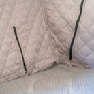 Close-up of the La Sal Insulation Walls by CVT, featuring quilted light gray fabric and two black zippers—one on each side—perfect for creating a cushioned corner and enhancing tent warmth during winter camping.