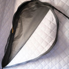 A close-up of an open CVT Mt. Hood Insulation Walls storage bag with a zipper, displaying its gray interior and white, diamond-patterned exterior—ideal for cold-weather camping thanks to its insulated liner that helps retain warmth.