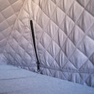 Close-up of the CVT Mt. Hood Insulation Walls, showcasing quilted light gray fabric with diamond stitching and a black zipper. The padded material serves as an insulated liner, designed to enhance tent warmth during cold-weather camping.