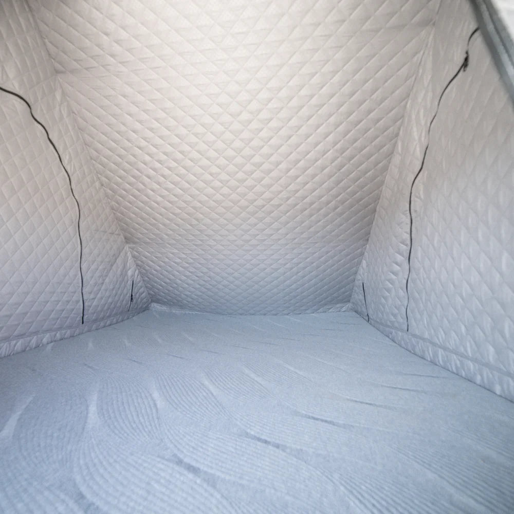 Interior view of a tent featuring the CVT Mt. Hood Insulation Walls, with quilted, silver-gray panels and an insulated floor that create a cozy, padded environment—perfect for maintaining warmth during cold-weather camping. The photo highlights the spacious interior and textured finish provided by the Mt. Hood Insulation Walls, with no objects or people inside to showcase the liner’s design and comfort.