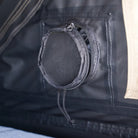 Close-up of a round, zippered mesh vent on the black wall of the CVT Mt. Hood 2 Hardshell Tent, with a beige section of the tent visible on the right—an ideal feature for outdoor adventures.