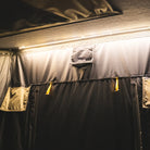 Interior view of the CVT Mt. Hood 2 Hardshell Tent, featuring durable fabric walls, zippered panels, mesh windows, and warm yellow ambient ceiling lighting—perfect for your next outdoor adventure.