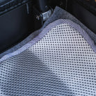 Close-up of the CVT Anti Condensation Mat in grey and white, featuring a textured mesh pattern. The mat is placed inside a black crate or container, highlighting part of a metal hinge and suede-like lining for effective moisture protection.