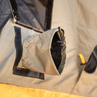 A close-up view of the CVT Pioneer 2 Softshell Tent’s ventilation port showcases its fabric tube and drawstring, neatly sewn onto the tent wall with visible stitching in signature green and yellow fabric—an essential feature enhancing comfort on overland adventures.