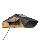 The CVT Pioneer 2 Softshell Tent features a tan and black cover with yellow trim, two awning-style windows, and an access ladder, making it ideal for mounting on your vehicle roof for overland adventures.